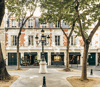 square in Paris with tree, lantern as traveller reflects on slow travel