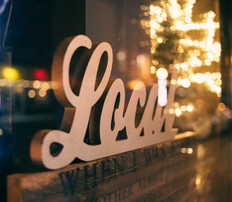 Display in store window with the word, local, in cursive type font.