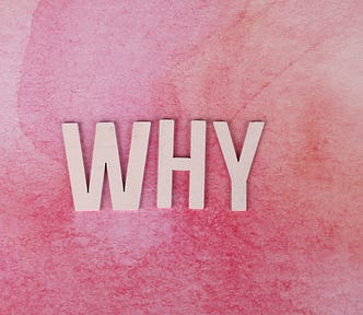 The word why against a pink-colored background