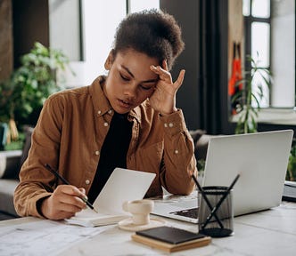 Picture of a woman taking some notes.