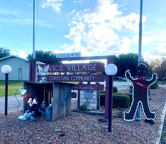 A photo I took of the RVICS Village entrance with its Christmas nativity scene and gingerbread man.