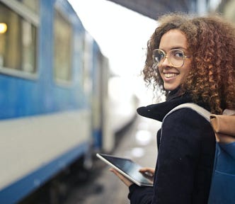 A young woman about to board a train.