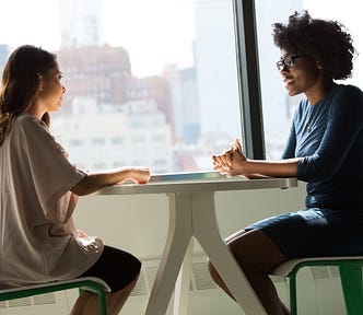 Two women sitting in an casual interview setting