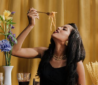 A woman eating spaghetti.