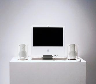 photo of an old iMac on a pedestal