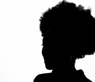 silhoutte of a black woman with an afro