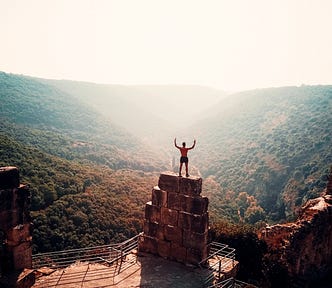 man standing on top of mountain