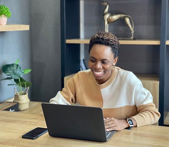 Photo of Nabhel working in an office, looking at her laptop.