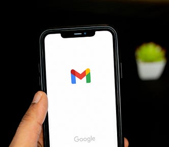 Hand holding a smartphone displaying Google logo.