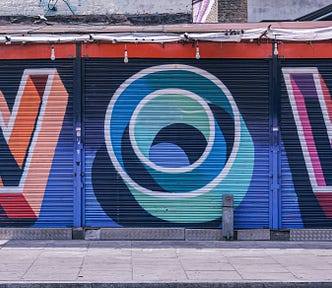 Graffiti reads “WOW” on metal building