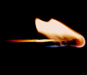 A lit match with a rainbow flame