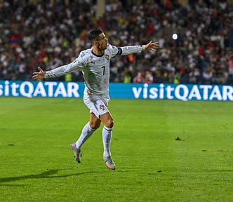 Cristiano Ronaldo running on the field with his arms open
