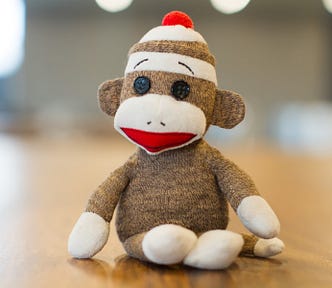 a quirky and lovable monkey made of socks with earnest looking eyebrows