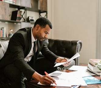 Well-groomed formally-dressed man working intensely