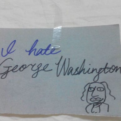 A piece of paper that says “I hate George Washington” in cursive. Under the sentence is an ugly caricature of the president.