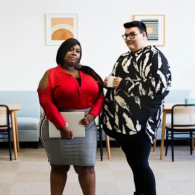 Group of plus size employees in a modern, bright open office