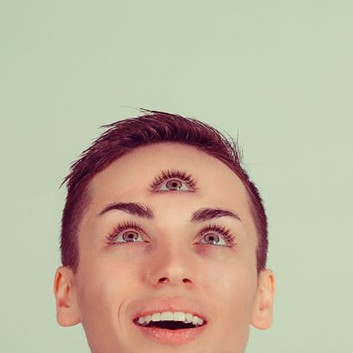 person looking in happy suprise towards third eye on forehead