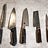 An image of five high quality knives including a bread knife, Chef’s knife, Santoku, Nakiri and Shoto knives.