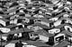 Vintage black-and-white photo of a densely populated suburban neighborhood of single-family homes. A wavy effect has been added to the photo.