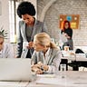 Three overwhelmed office workers looking at computer