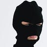 Close-up Shot of a Person Wearing a Robber Mask