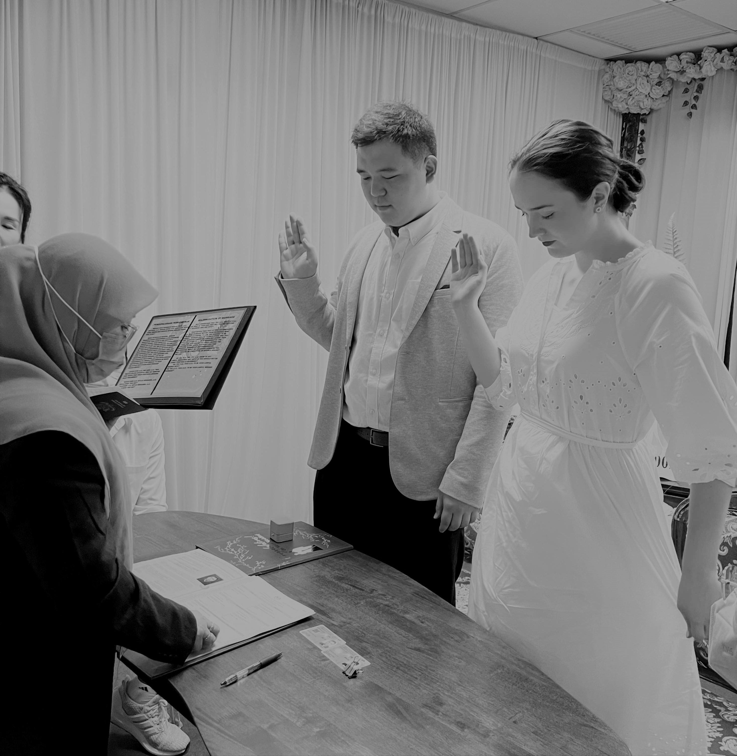 Picture of young couple in front of wedding officiant