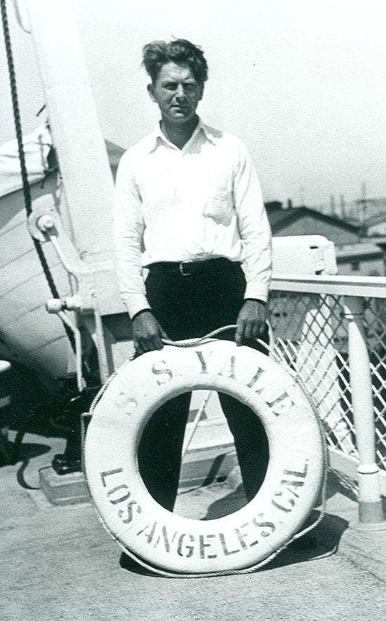 Man standing on deck of boat circa 1935