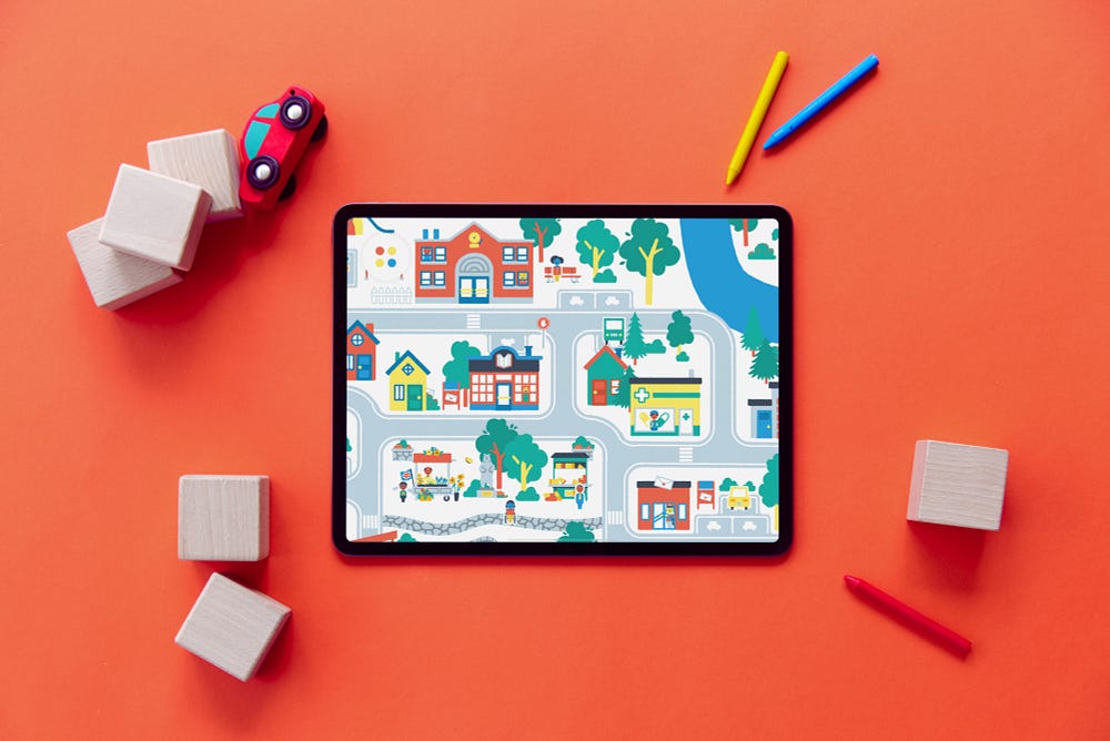 An iPad featuring a toy in the Pok Pok Playroom, surrounded by wooden blocks and crayons.