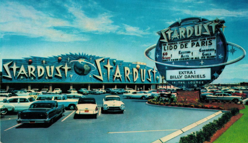 Public domain, (cc-zero, image retrieved via Wikimedia Commons), Title: “Stardust” (early 1960s postcard); Unknown and uncredited photographer; Date: 1 January 1960; Source: Vintage postcard dated no later than 1965. The round roadside sign for the Stardust was replaced in 1965.