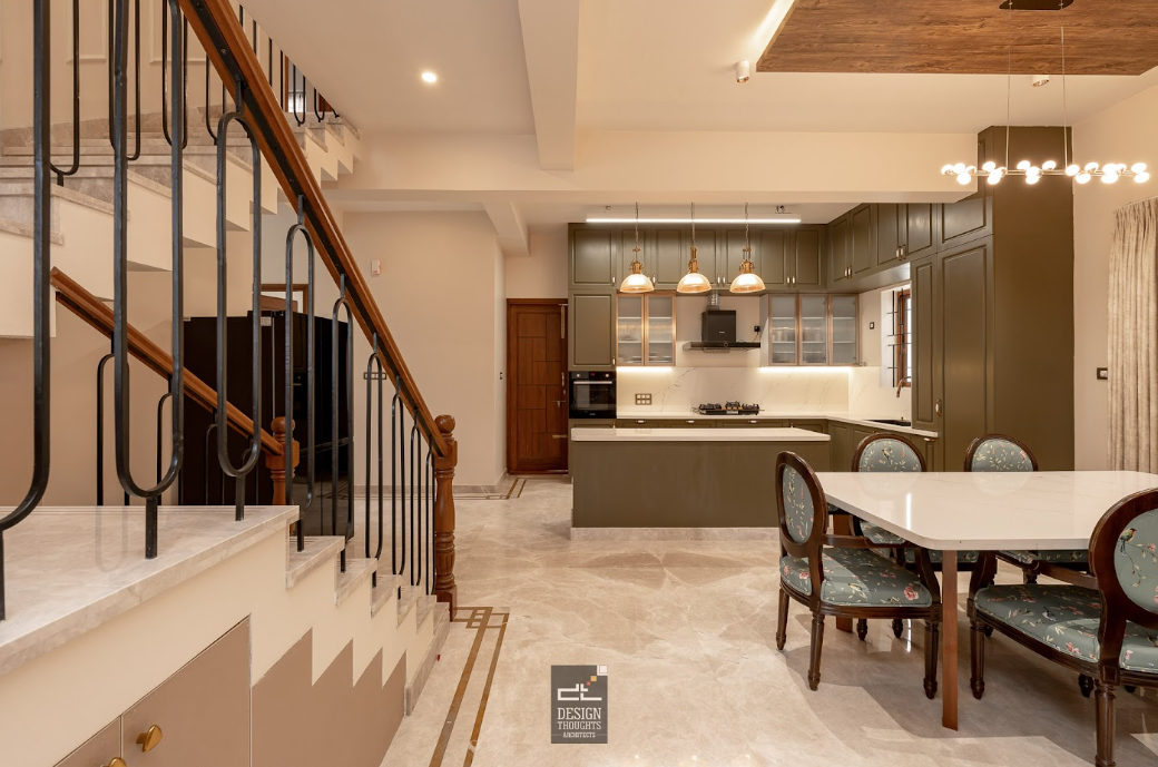 The views of the kitchen from the staircase and dining give a better understanding of scale.