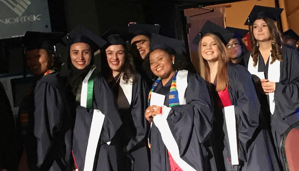 People posing with graduation robes.