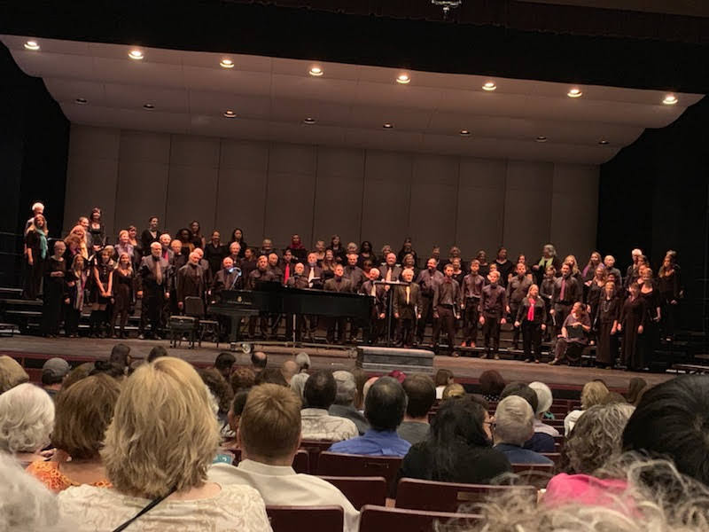 People singing on a stage.