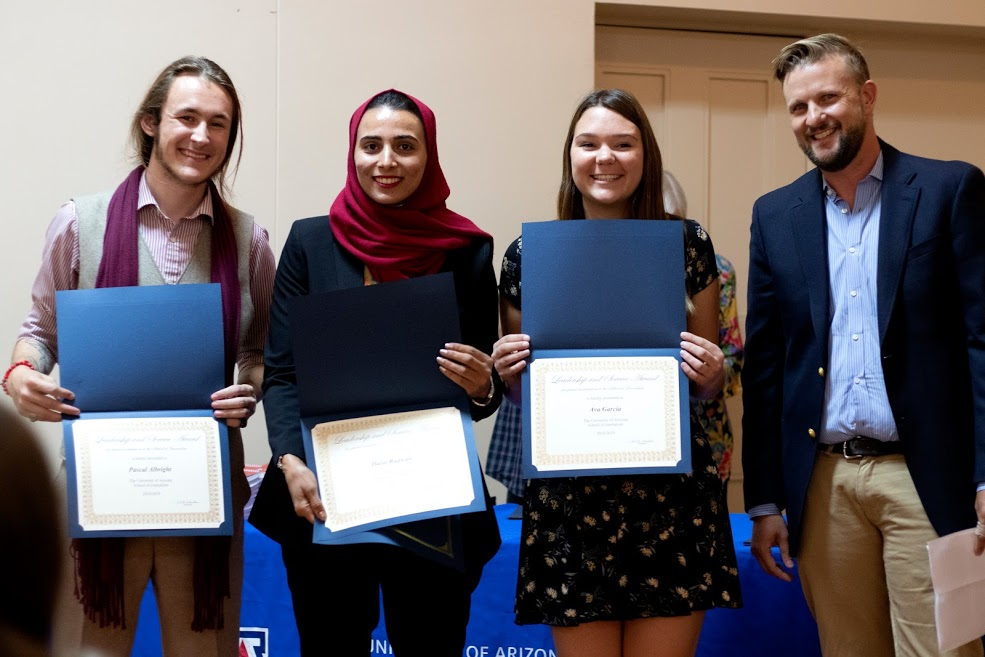 People holding certificates.