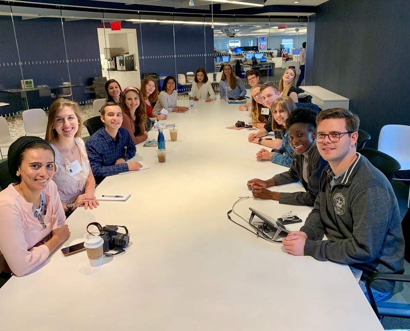 People sitting at a conference table.
