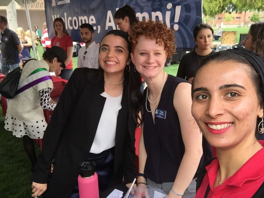 Women taking aelfies at a tabling event.