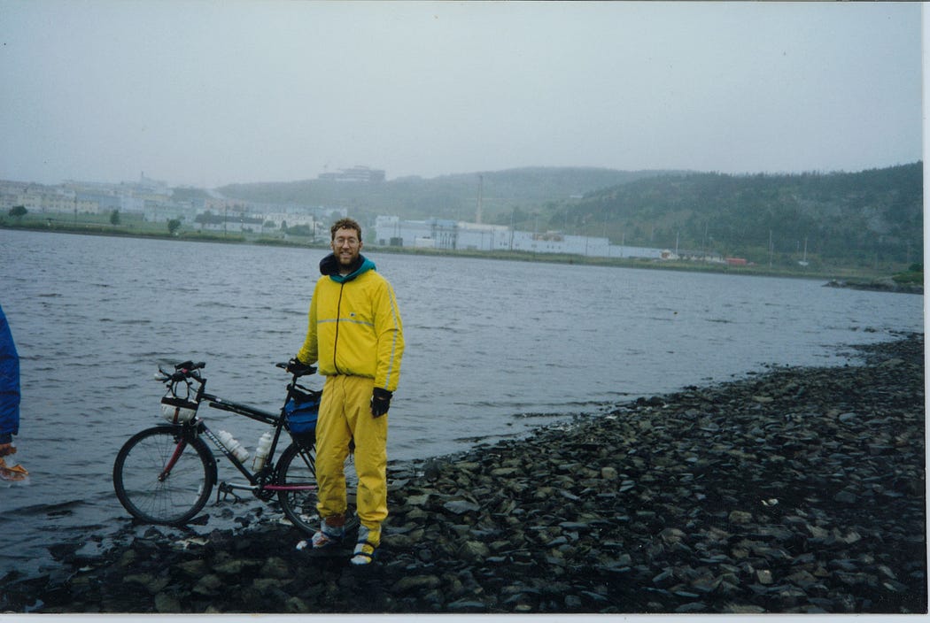Me in St. John’s, Newfoundland, front wheel of bike in Atlantic Ocean, September 1992
