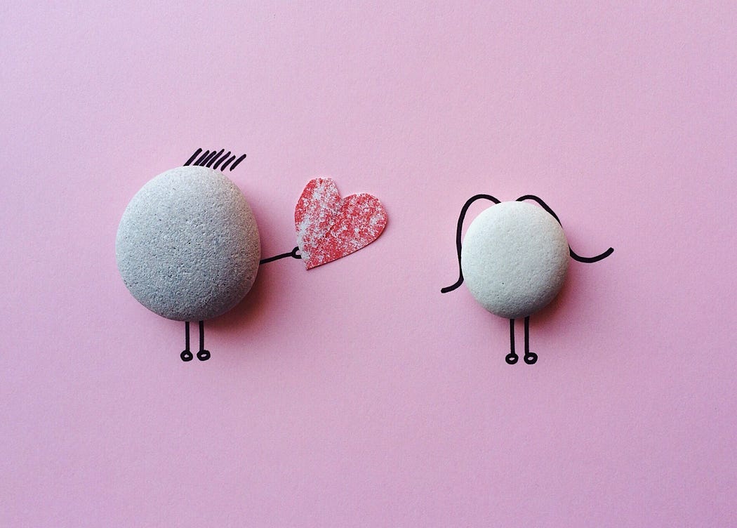 One stone giving valentine to another stone.