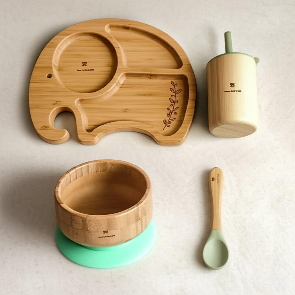 A four-piece bamboo tableware set for babies and toddlers for baby-led weaning is placed on a countertop.