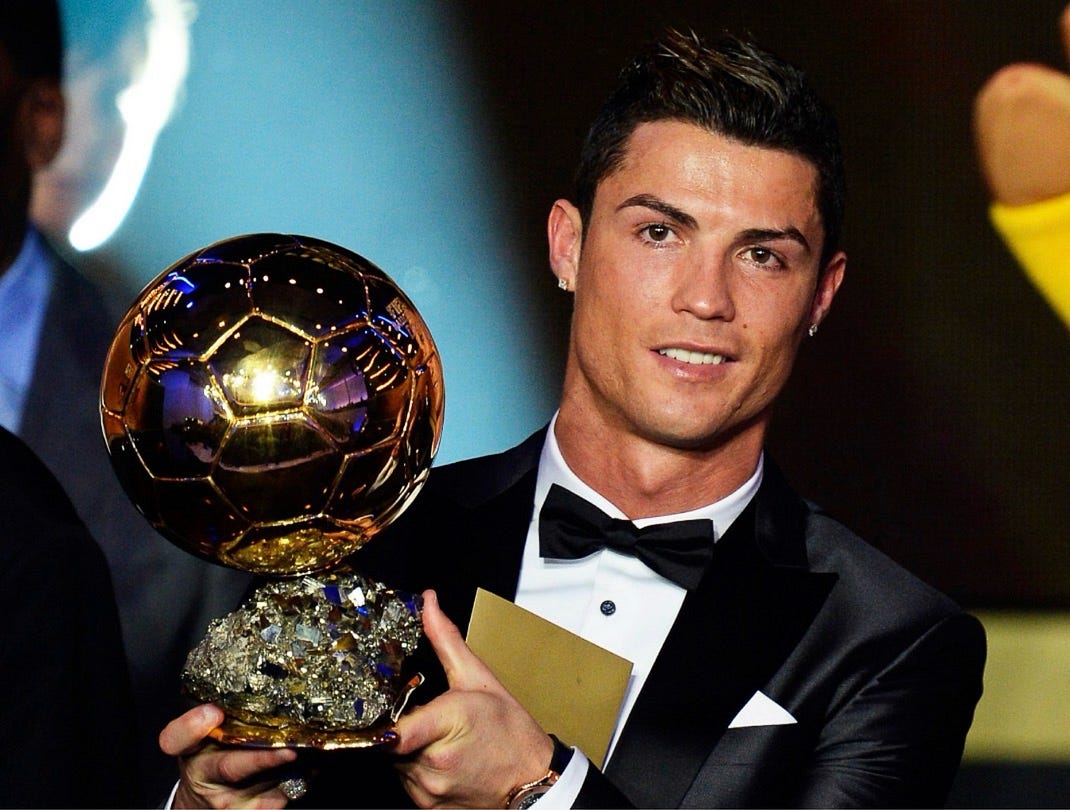 Cristiano Ronaldo with the 2013 Ballon d’Or after a 69-goal season.