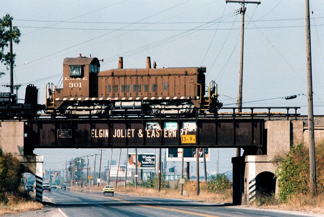 An EJ&E SW1200 №301 crossing at the Industrial Highway flyover. Demolished.
