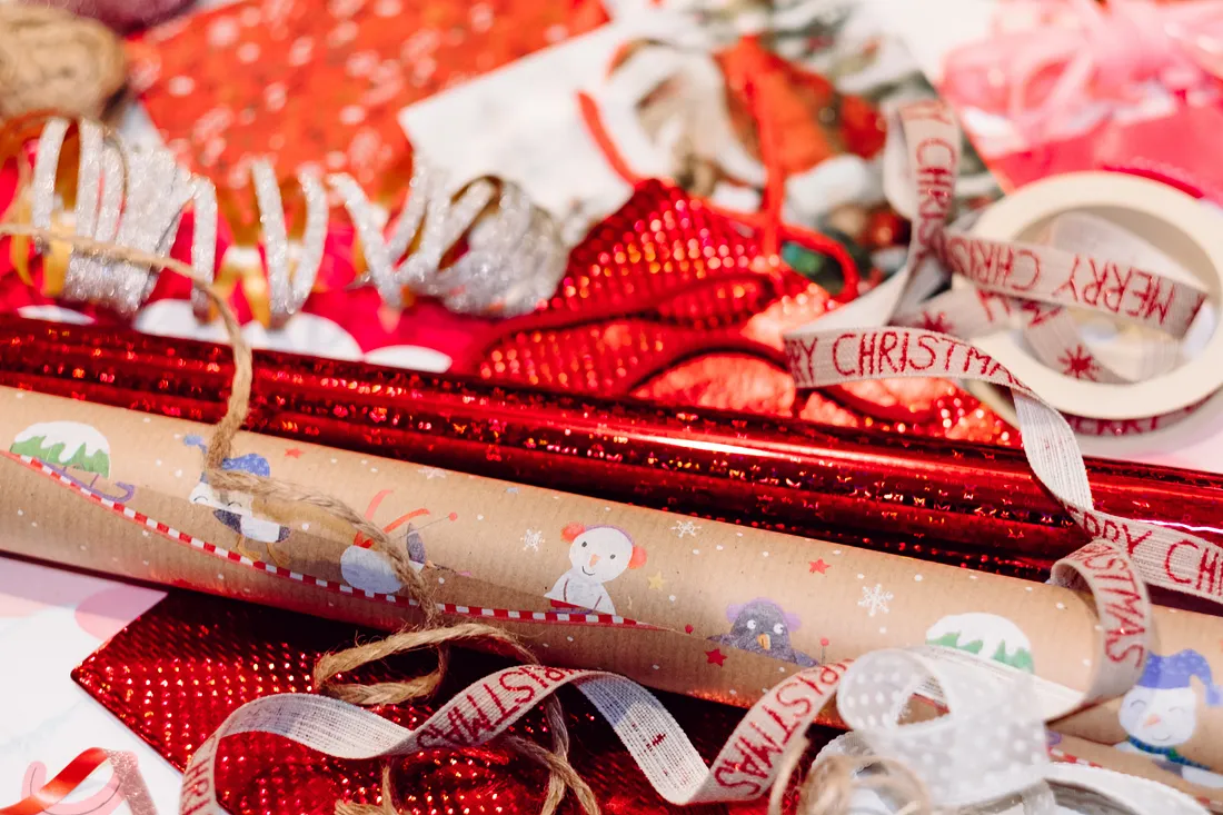 Multiple rolls of wrapping paper scattered on the ground.