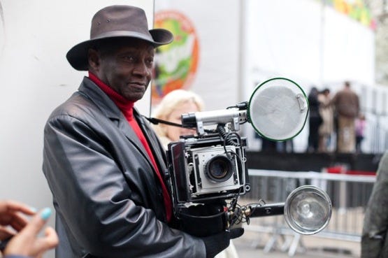 photo 1 - Louis Mendes and his jumbo Speed Graphic camera have been  fixtures on #NYC #streets for more than 60 years. Always looking dapper…