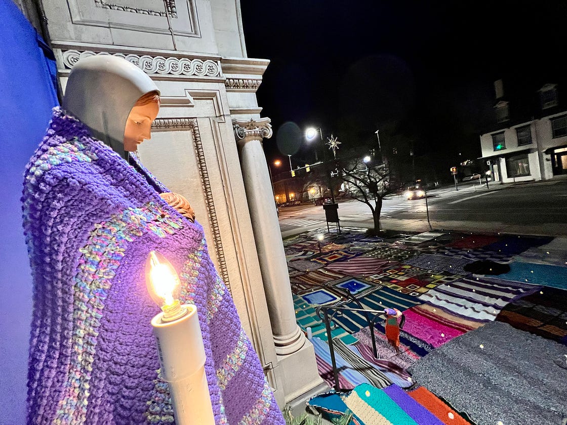 statue of Mary with a knitted blanket