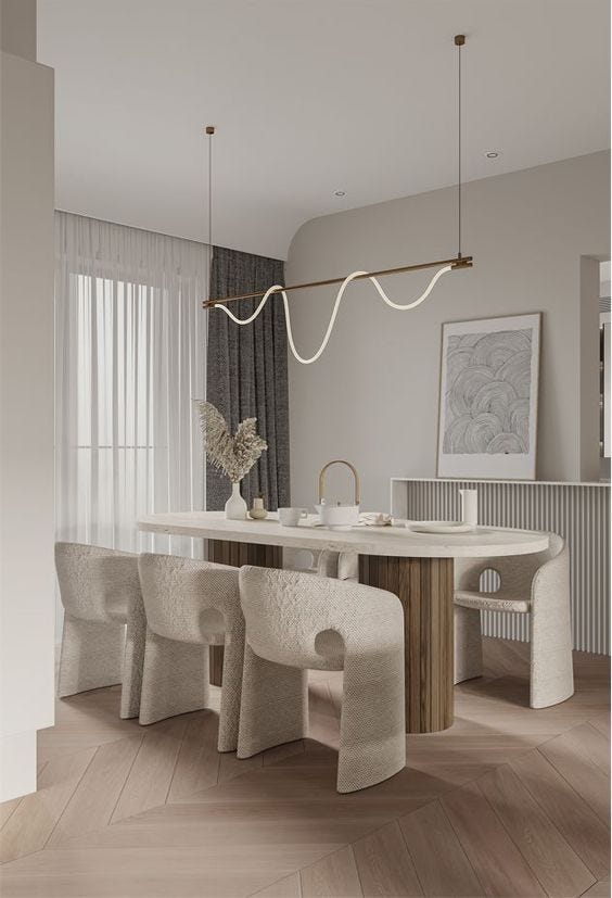 modern dining room with white chair and a cursive pendent light