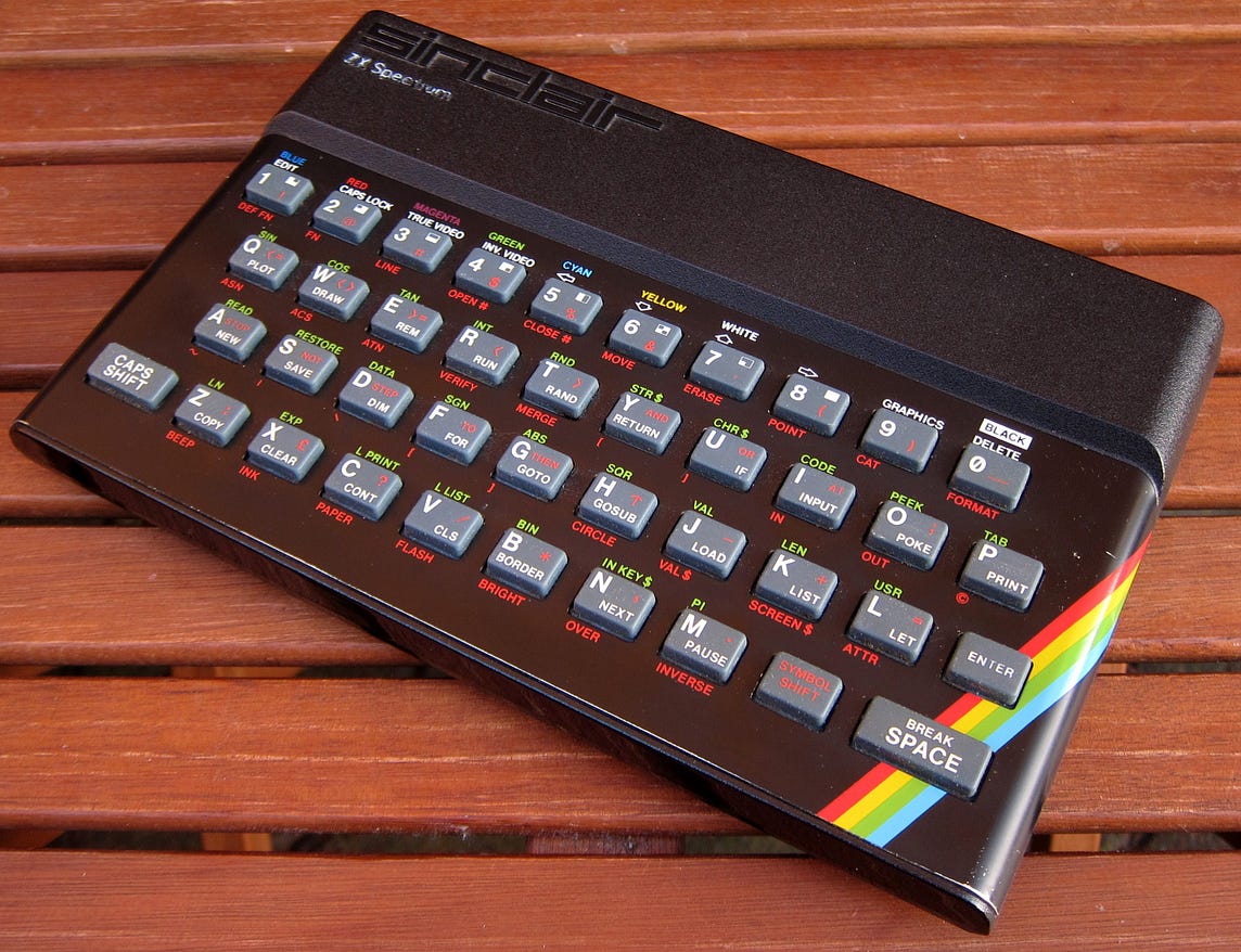 A slightly tatty-looking Sinclair ZX Spectrum 48K on a wooden table