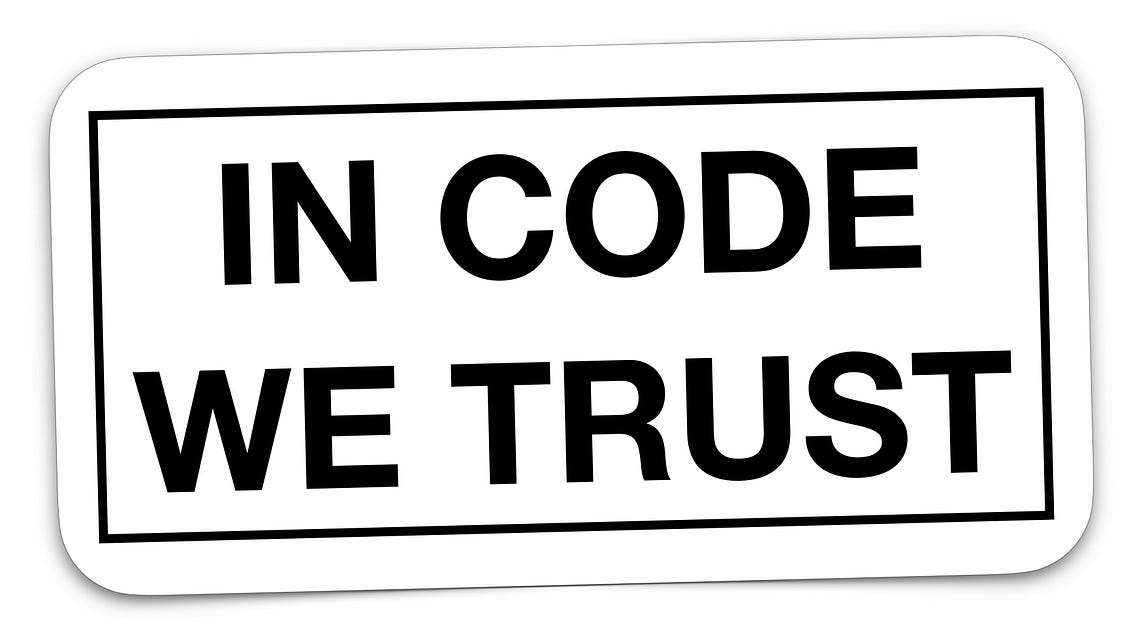 IMAGE: A white sticker with the words “In code we trust”