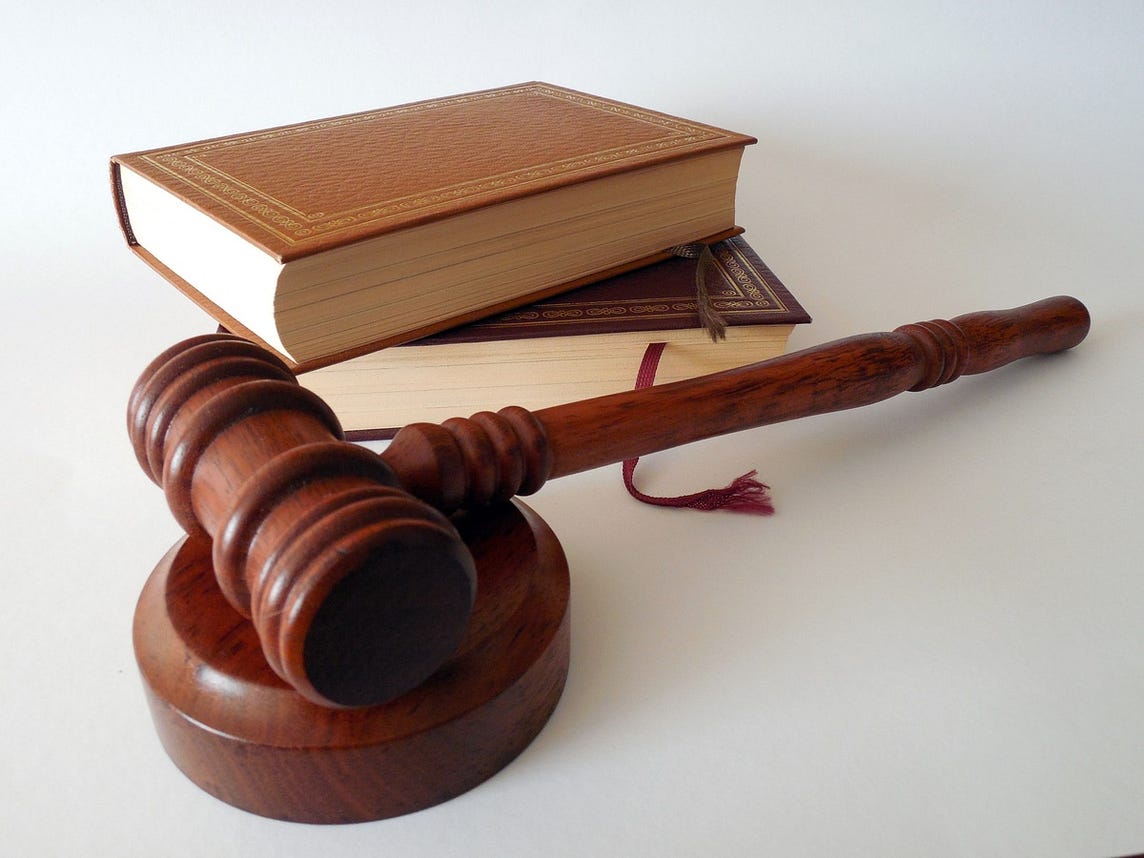 IMAGE: A judge’s gavel and a couple of books