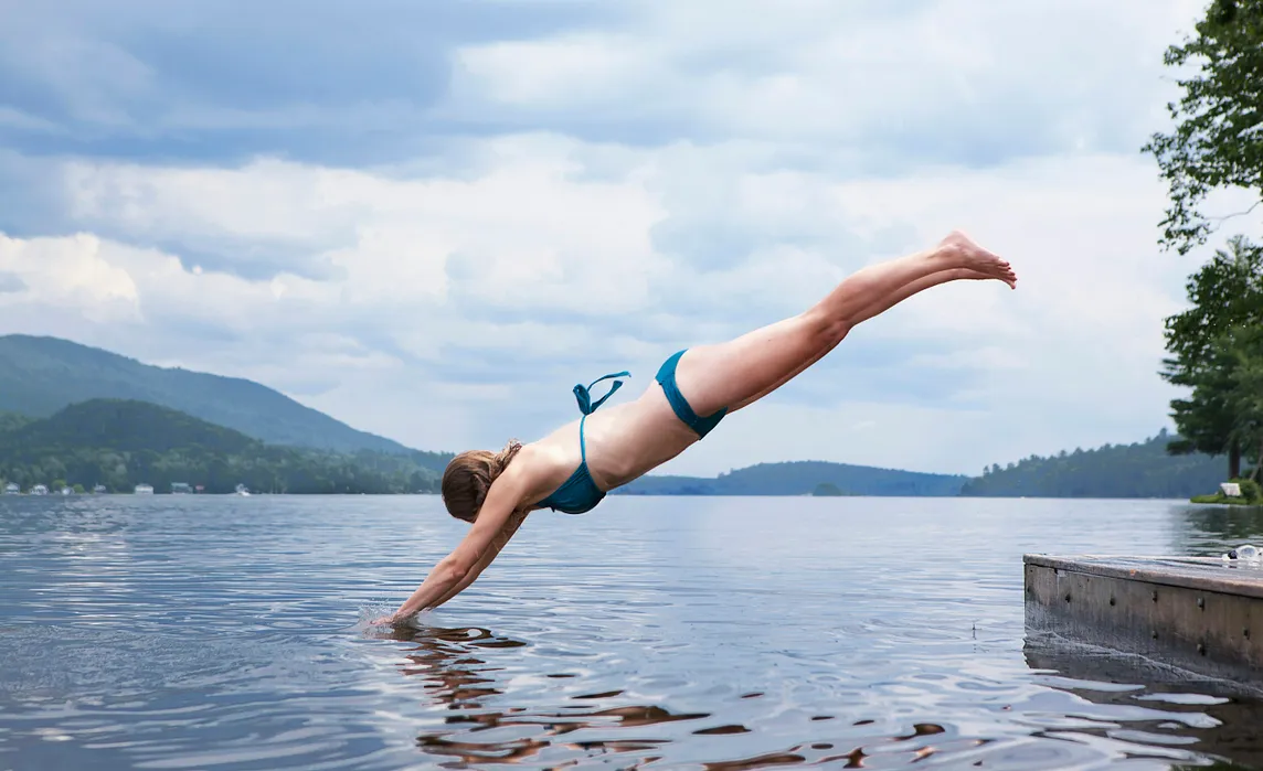 A person diving into a lake head first