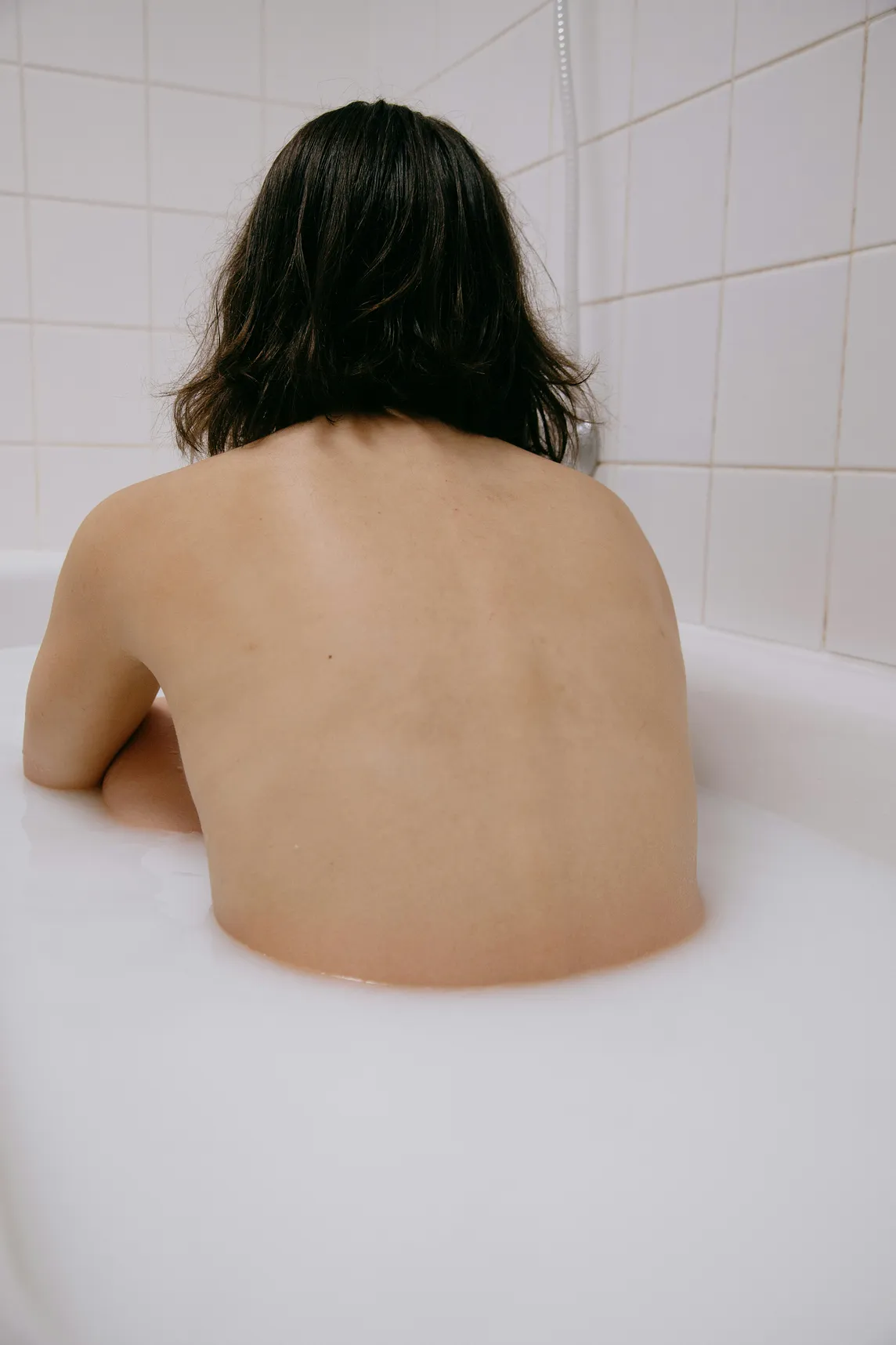 A woman sitting in a bathtub