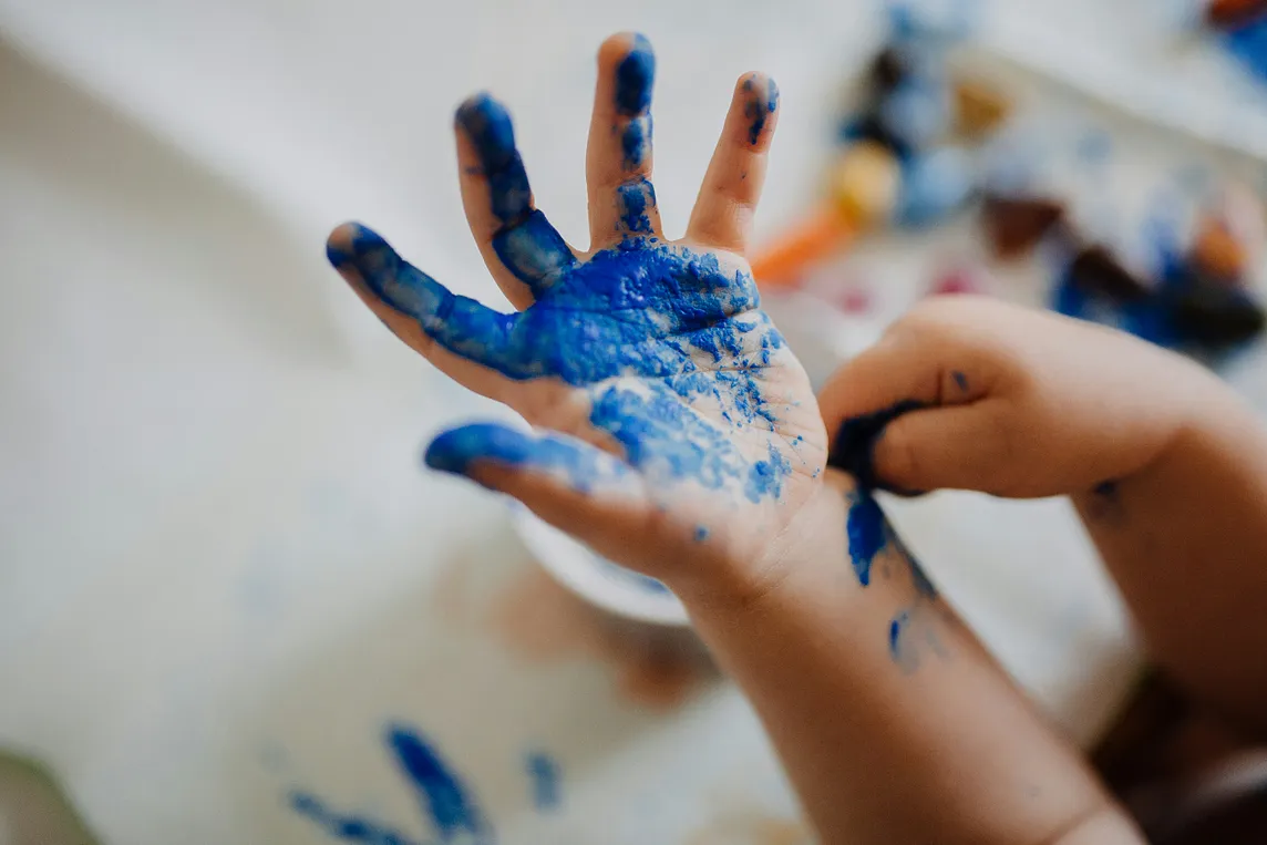 A picture of kid’s hand in paint. Childeren are imaginative